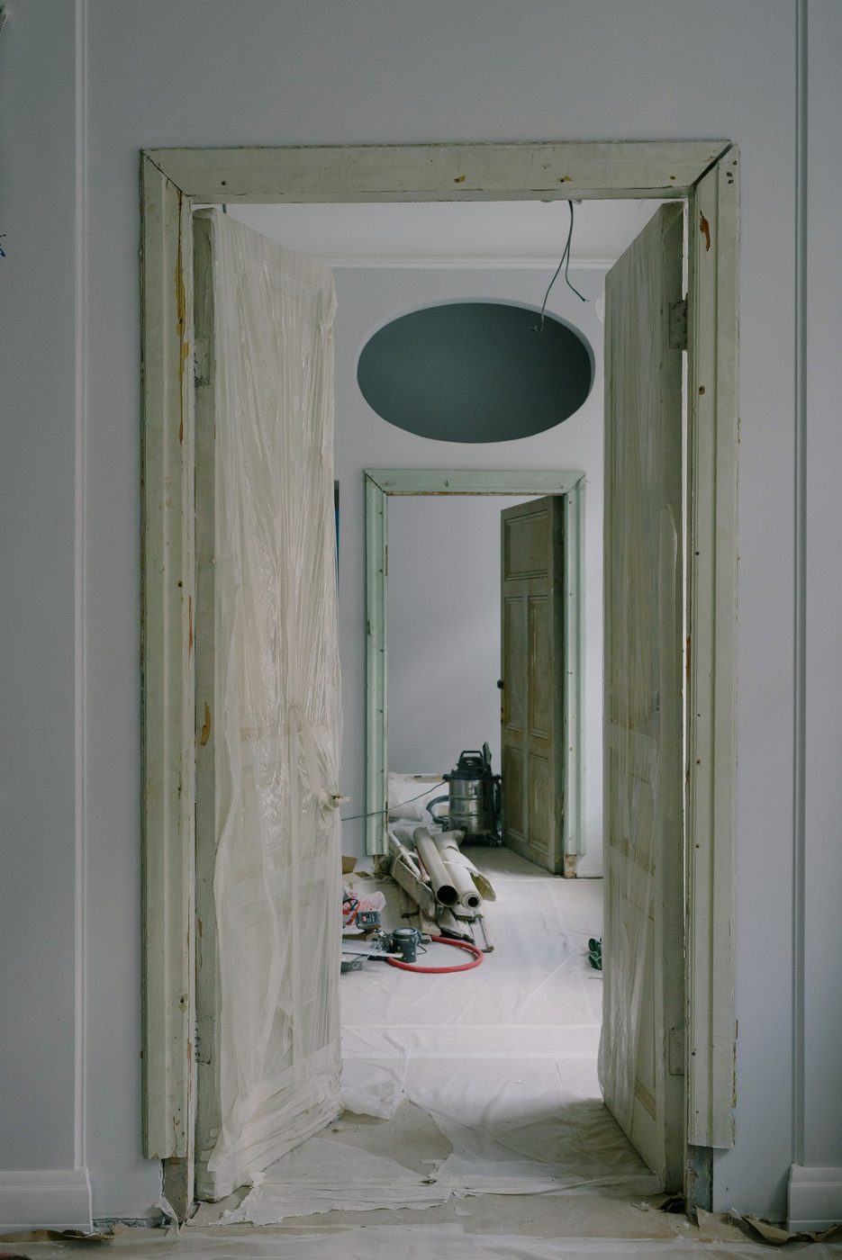 Foto de archivo. Vivienda a medias: puertas protegidas con plástico y pasillo con materiales de obra.
